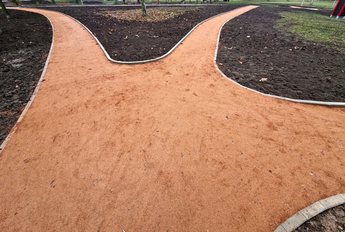 Finished concrete curbing along residential driveway with clean landscape edging